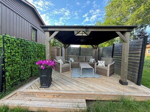 Private covered deck with outdoor ceiling fan ideal for entertaining.