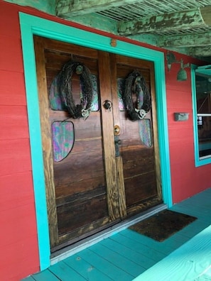 Hand made doors with Stainglass windows provide main entrance to rental.