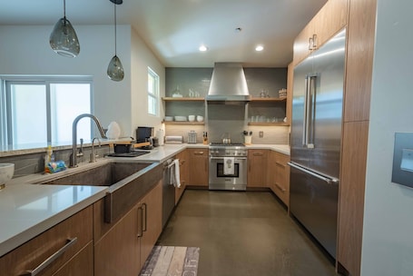 Clean kitchen offering high-end stainless steel appliances