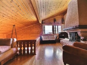 The top floor features a living space with a warm fireplace.