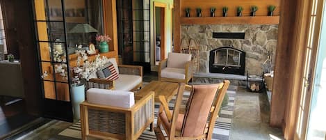  Patio style living room next to the indoor hot tub.
Wood fireplace and wet bar