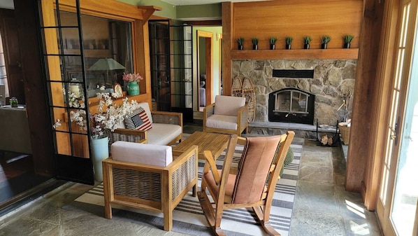  Patio style living room next to the indoor hot tub.
Wood fireplace and wet bar