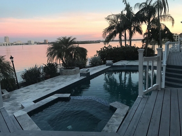 Back of the home and pool at sunset 