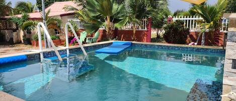 Pool is located in the garden and is shared between all guests.