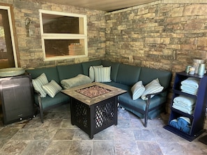 Private screened in porch with seating for 4, fire pit table, and wine fridge