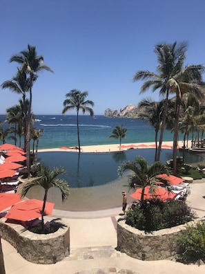 Infinity pool with view of white sand beach and Land's End