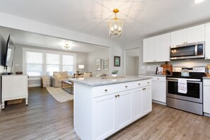 Fully stocked kitchen open to living room 