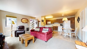 Living room with sofa sleeper, flat screen TV, and fireplace