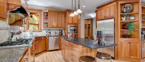 Prepare meals in spacious well equipped kitchen with island