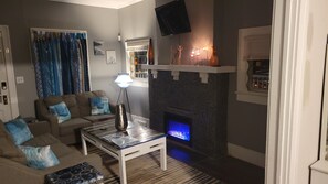 Cozy (small) living room with electric fire place and Roku TV