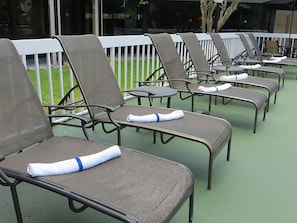 Large swimming pool and poolside loungers