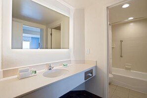 Bathroom with shower and tub. Basic toiletries and towels are provided