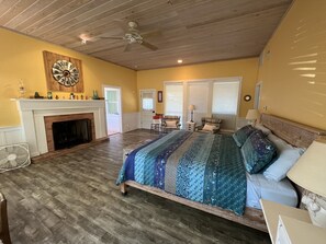 Huge master bedroom with electric fireplace.