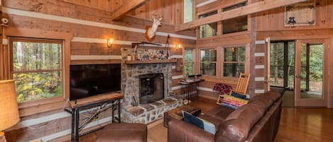 Entry view of main level living space with entrance to covered, screened-in patio to the right through French doors