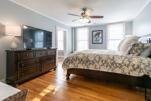 The bright King bedroom has its own flat-screen TV.