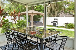 Enjoy dinner in the screened back patio overlooking the spacious fenced backyard
