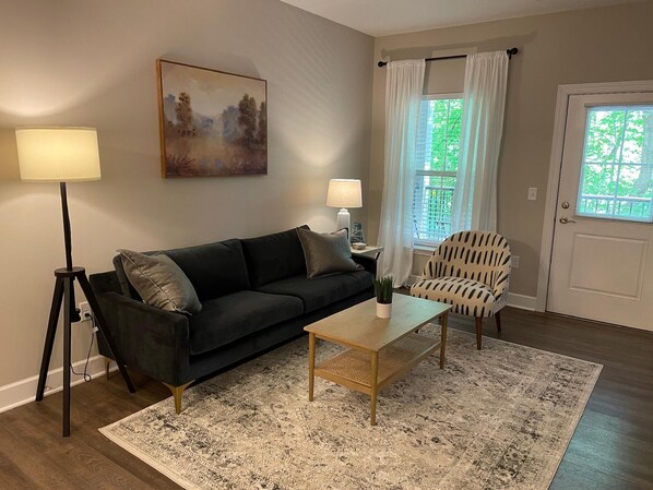 Our living room features super comfortable furniture including this side chair and a beautiful sofa. The TV is already logged in to DirecTV.