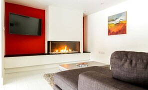 The living room with electric fire at The Shippon Cottage, Lake District