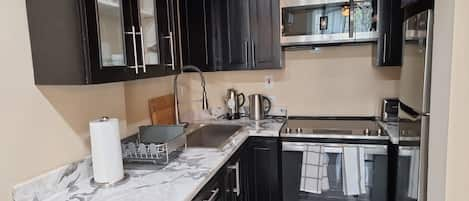 Full kitchen with all upgraded appliances, microwave, electric stove, &more.