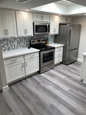 Brand new kitchen cabinets, appliances and fully stocked with dishes and utensil