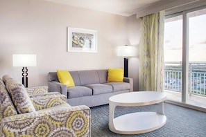 Separate Living area with a sleeper sofa and Door to the balcony.