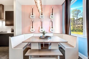 Open-concept dining room in Nashville with a guitar wall, perfect for music-themed photo opportunities and memorable meals.