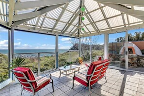Loft Retreat with Balcony and Wet Area. BBQ, pizza oven, and timber dining table for shared meals