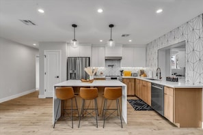 Open kitchen with large island. Includes all you need to make gourmet meals.