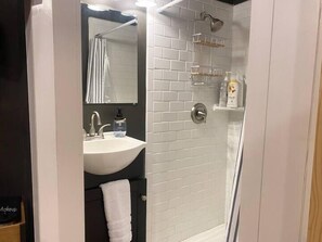 Master en-suite with walk-in subway tile shower.