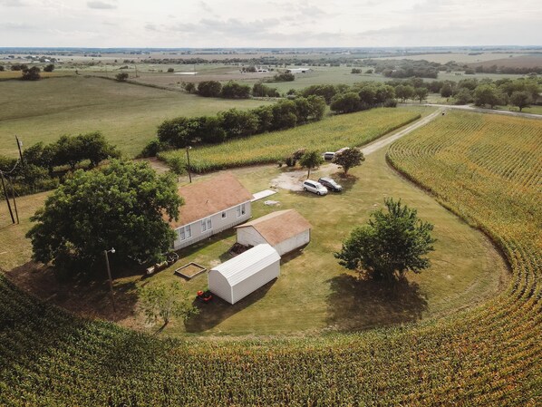 Parking on the white rock. Long driveway from main gate. Crop grows in summer.