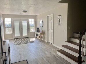 Kitchen w/ door to back deck and exit to backyard.  Stairs to 3rd floor rooms.