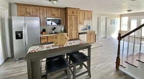 Kitchen and table.  Convection microwave oven and induction stove top and fridge