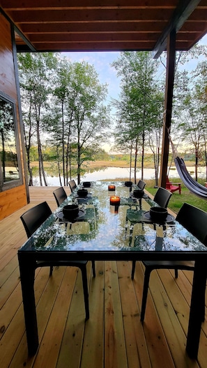 The side deck has a 6 seat dining table from Room & Board.