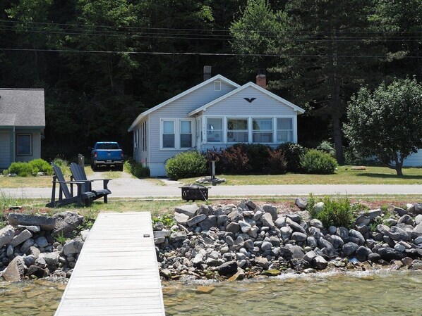 OVERALL:  The front of the cottage, highlighting the private dock and bonfire ring.