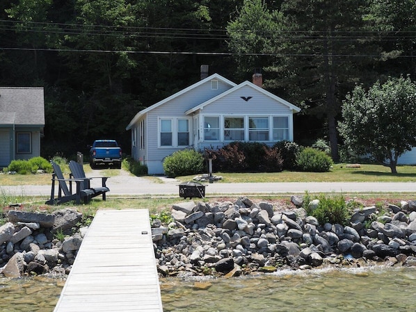 OVERALL: The front of the cottage, highlighting the private dock and bonfire ring.