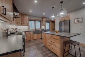 Kitchen with high end appliances and island with four seats