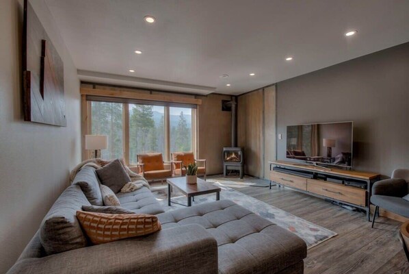 Living room with wood stove and flat screen TV