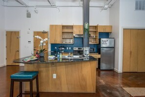 Cook and entertain in a sleek, fully-equipped kitchen featuring modern appliances, ample counter space, and all the essentials for a seamless dining experience in the heart of Fort Worth.