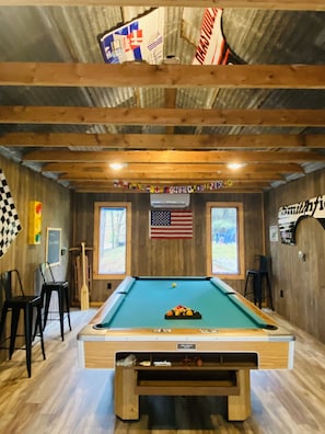 Game Room in Pocono Raceway theme w tin ceiling and car panels