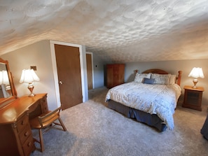 Queen's room - 2nd floor - queen bed with vanity, armoire and cozy chair. 