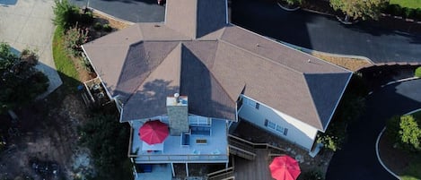 Overhead view of main home with two waterfront decks and Swim Spa and hot tub.