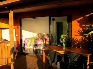 Terrasse couverte avec cuisine équipée, espace repas et salon extérieur