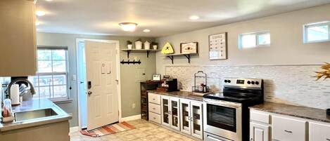 kitchen 
A wine cooler, microwave, stove, oven, toaster and more.