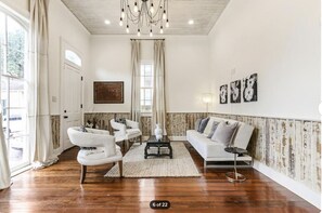 Living room number one with floor to ceiling windows.  