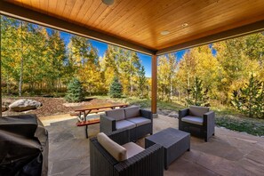 Private back patio offering a hot tub, grill, seating and fireplace