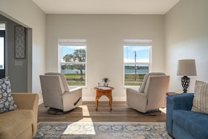 Swivel rockers in living room allow for conversations and tranquil lake views