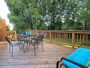 The deck/back yard is a treat with birch trees and huge lilacs - and yard games