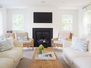 Living room with gas fireplace and lots of natural sunlight
