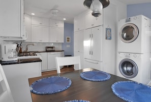 A dining space integrated with the kitchen, complete with a convenient washer and dryer setup