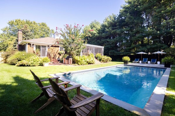 A pristine pool complemented by inviting lounge chairs.